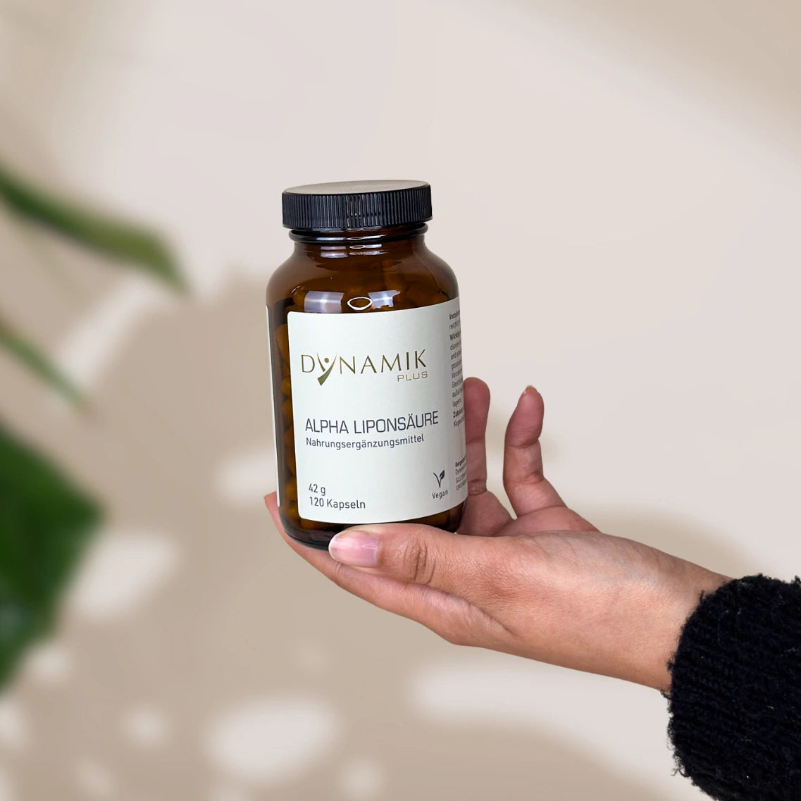 Brauner Glasbehälter mit DynamikPlus "Alpha Liponsäure" Etikett und schwarzem Drehverschluss
