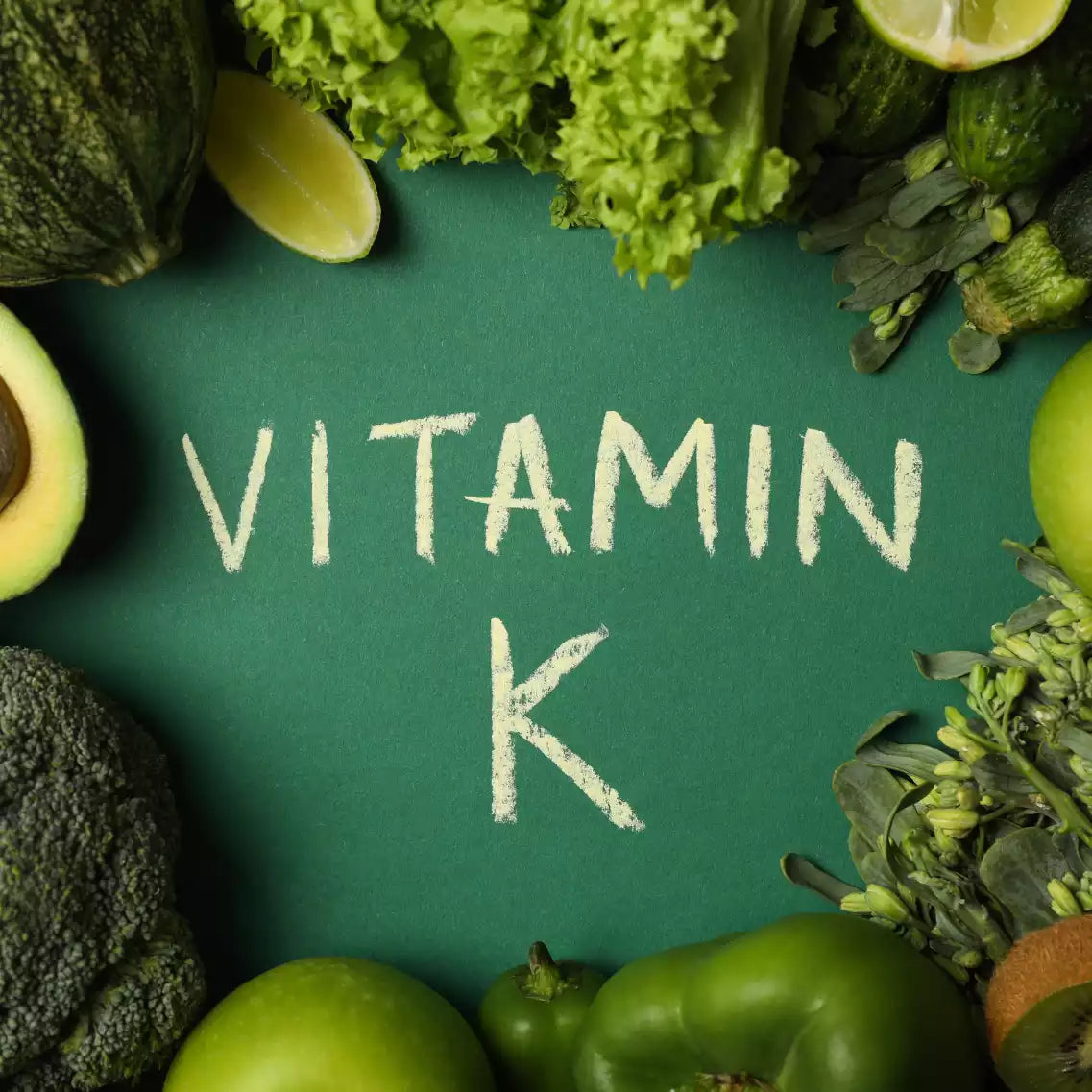 Schrift "Vitamin K" in der Mitte und umringt von Avocados, grünem Paprika sowie Salat